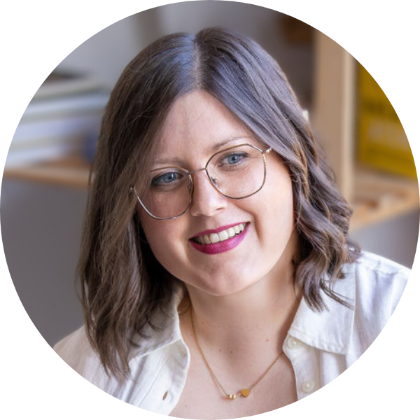 jenny-schmitz-ueber-mich Jenny Schmitz schaut interessiert das Gegenüber an, das im Bild nicht zu sehen ist. Der Kopf ist dabei schiefgelegt und sie lächelt sanft.